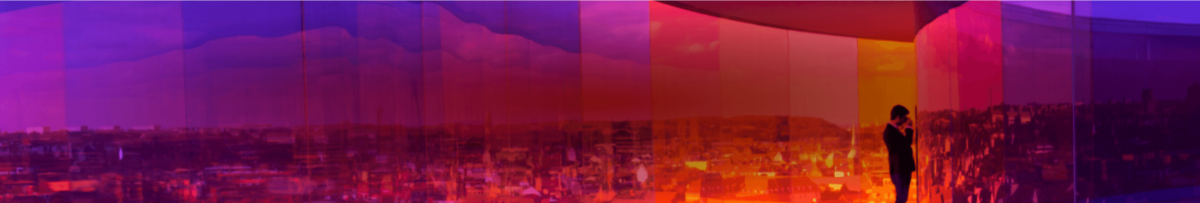 Jewel tone image of businessman looking over the city