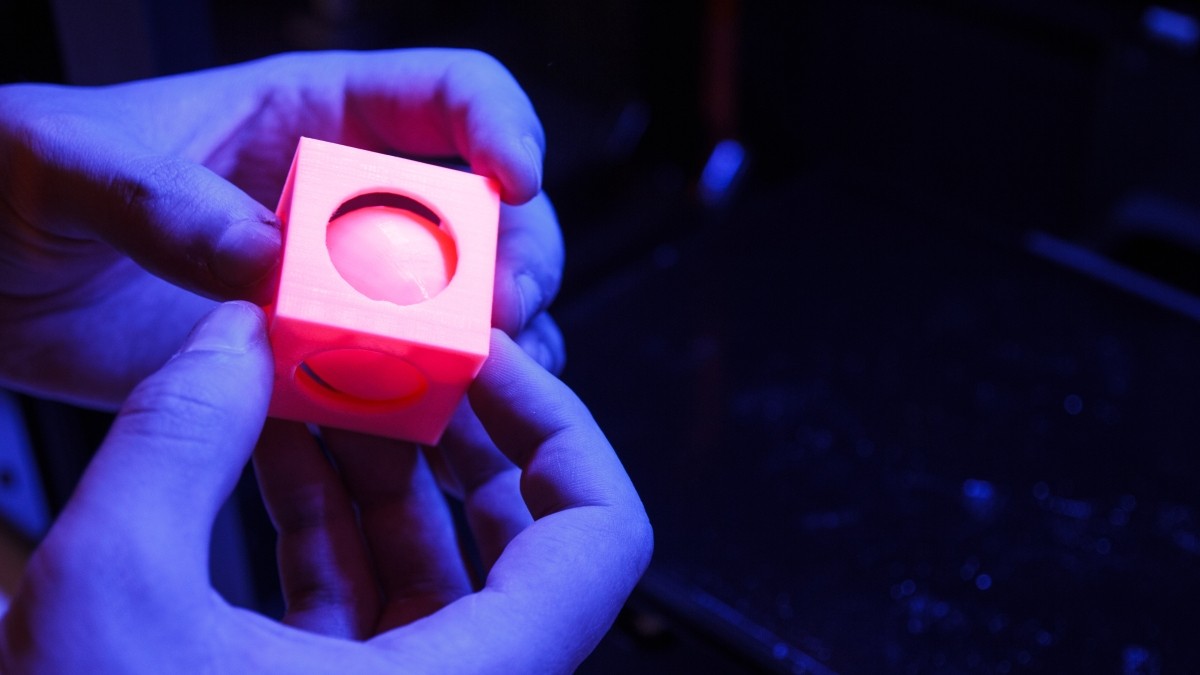 3D printed cube being held in a pair of hands