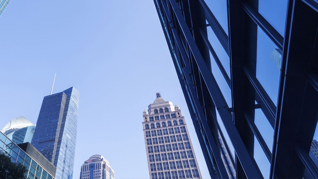 Blue photo of tall city buildings
